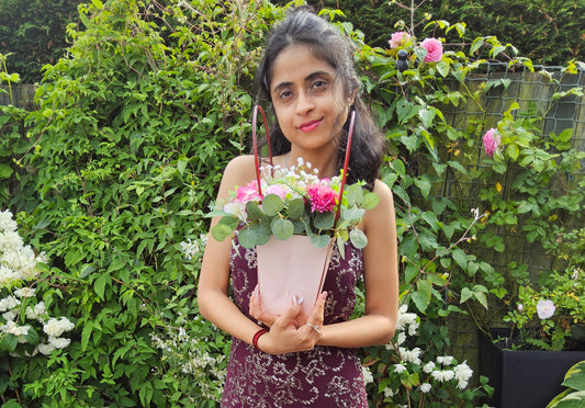 Out in the Town with these flowers in a pink handbag